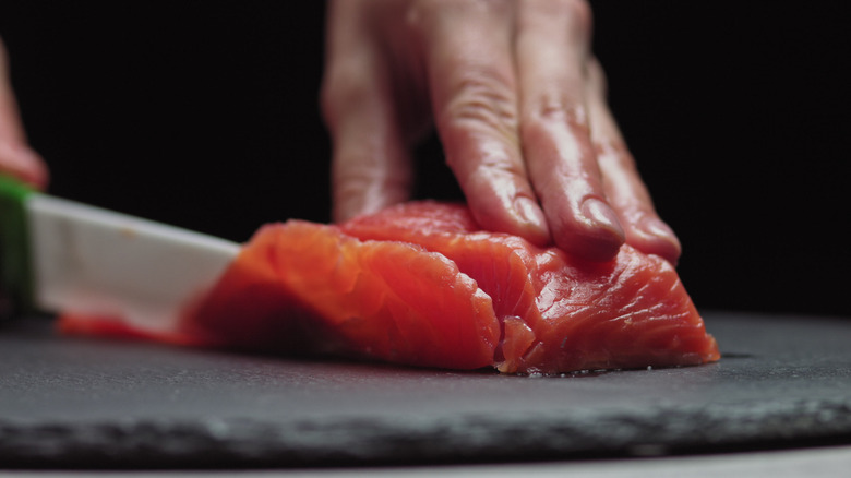 cutting raw salmon