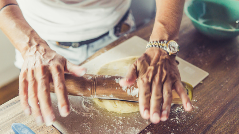Hands rolling scone dough