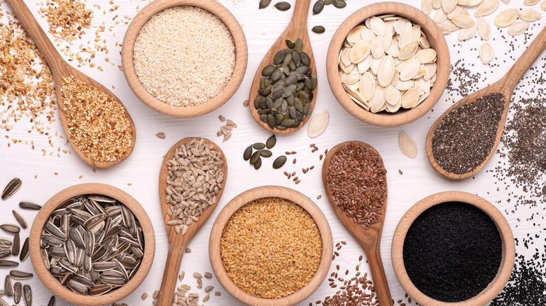 various seeds, wooden spoons, bowls