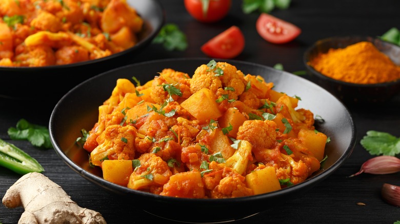 Aloo gobi in black bowl