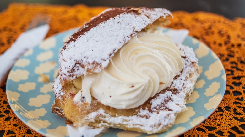 Fastelavnsboller on a plate showing a whipped cream filling