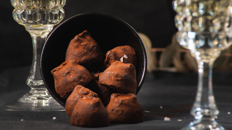 Chocolate truffles with Champagne glasses in background