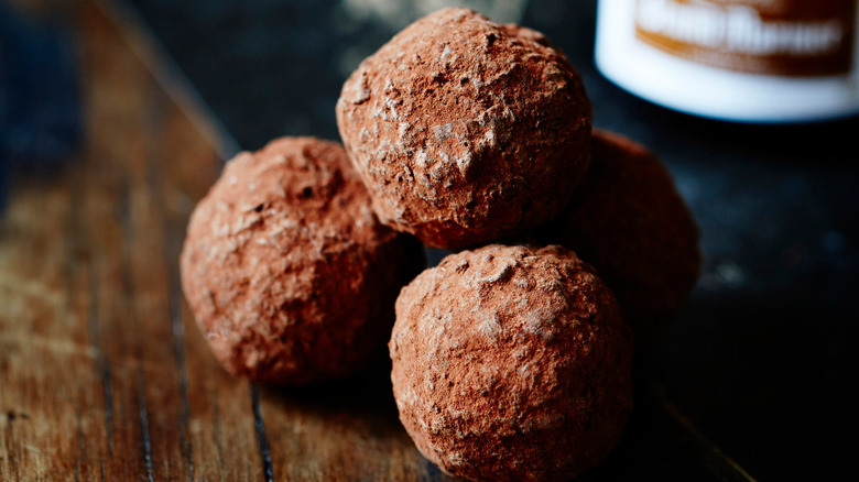 Stack of Grand Marnier truffles with blurred bottle in background