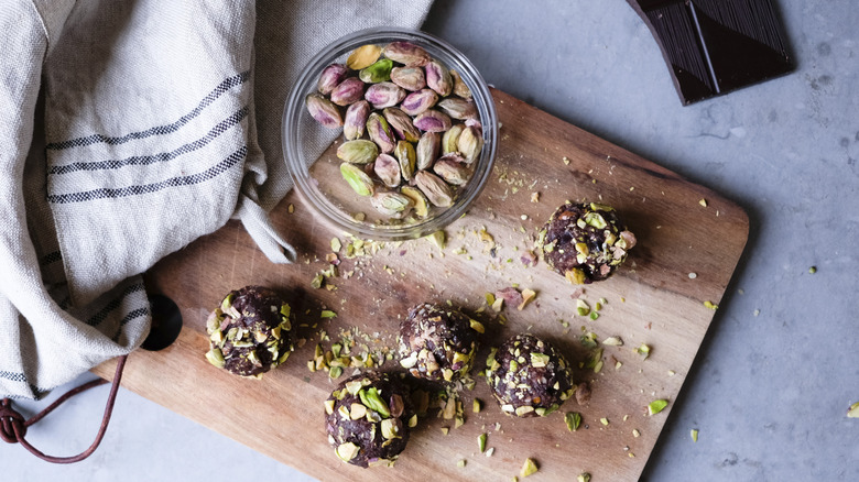 Pistachio truffles on wooden cutting board