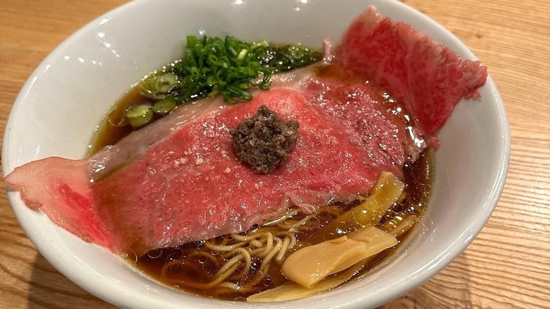 Wagyu beef ramen bowl on a wooden table at Akahoshi Ramen, Chicago