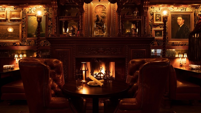 Interior of Armitage Alehouse, Chicago, with leather chairs, paintings, and a fireplace