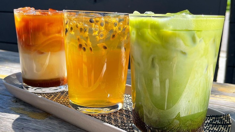 Three colorful drinks on a tray at Kasama restaurant, Chicago