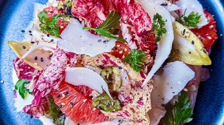 Winter citrus salad with chicories, fennel, and red onion on a blue plate at Monteverde, Chicago