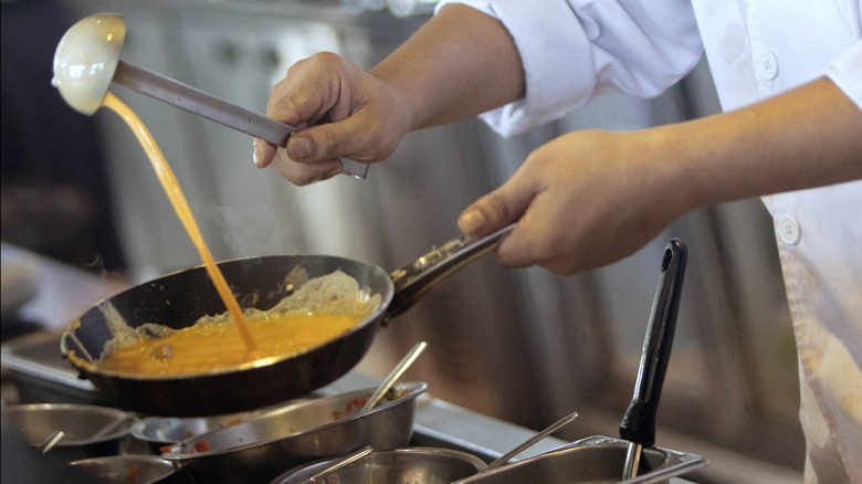 Pouring eggs with a ladle