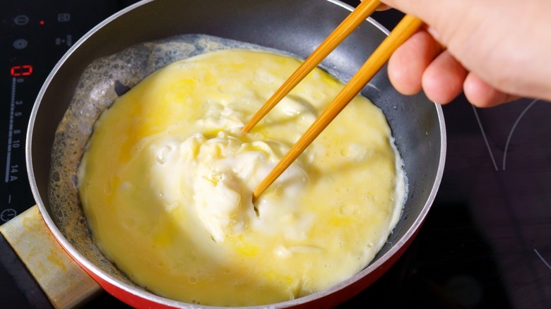 Cooking an omelet with chopsticks 