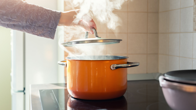 steaming orange soup pot