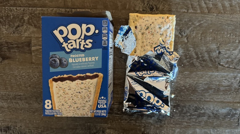 frosted blueberry Pop-Tart box next to unwrapped pop-tart