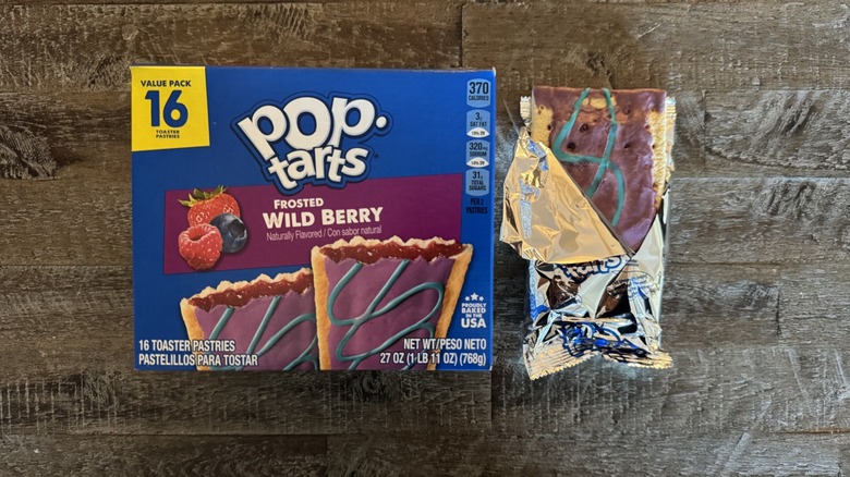 Frosted wild berry Pop-Tarts box next to unwrapped pop-tart