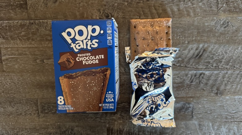 Frosted chocolate fudge Pop-Tart box next to unwrapped pop-tart