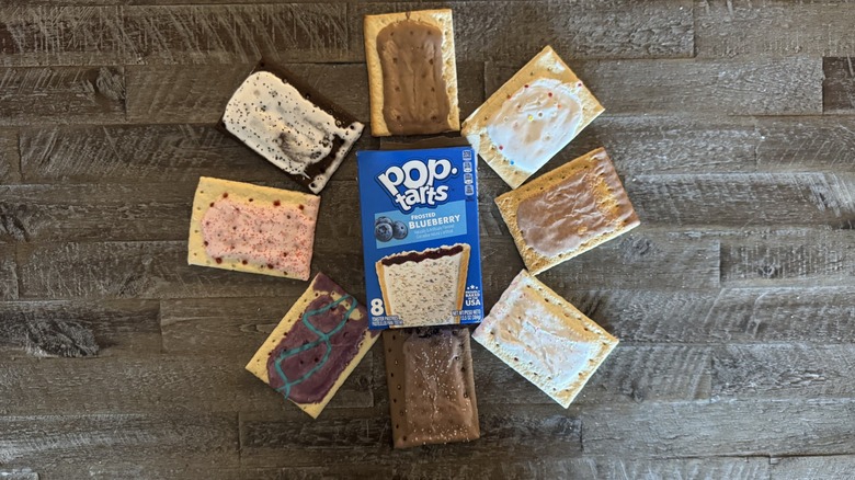 different flavored pop-tart pastries surrounding a blueberry pop-tart box