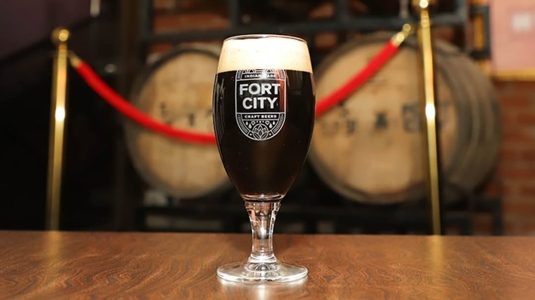 A glass of Fort City beer placed down on a table