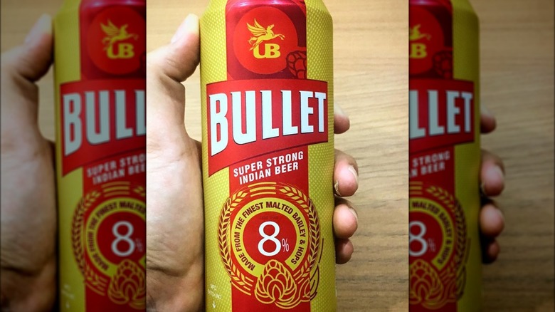 A can of Bullet beer being held in a hand