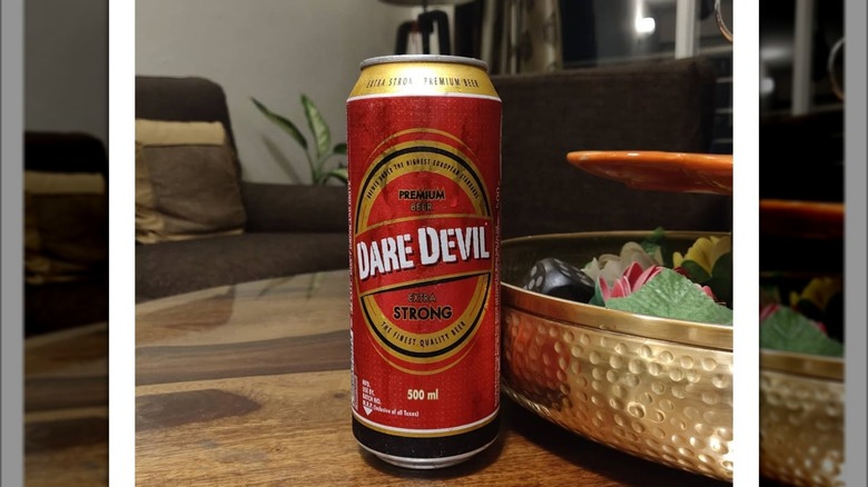 A can of Dare Devil Extra Strong beer resting on a table