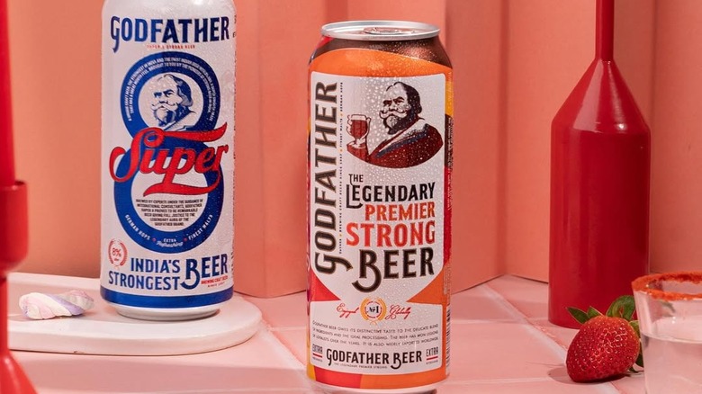 Two different cans of Godfather beer being presented