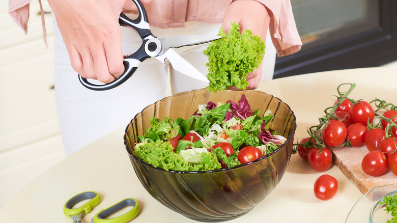 Kitchen shears chopping lettuce