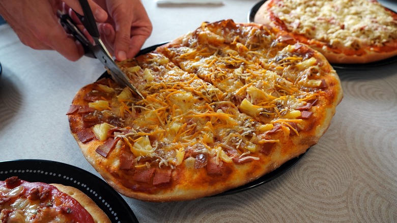 Shears cutting pizza slices