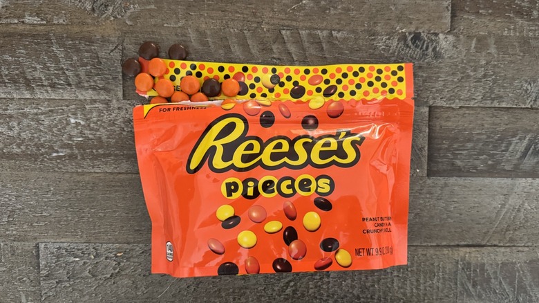 Reese's Pieces candy on wooden table