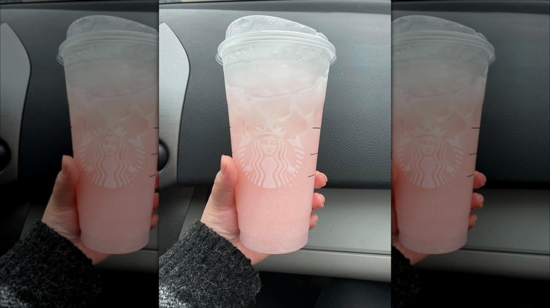 Light pink beverage in hand