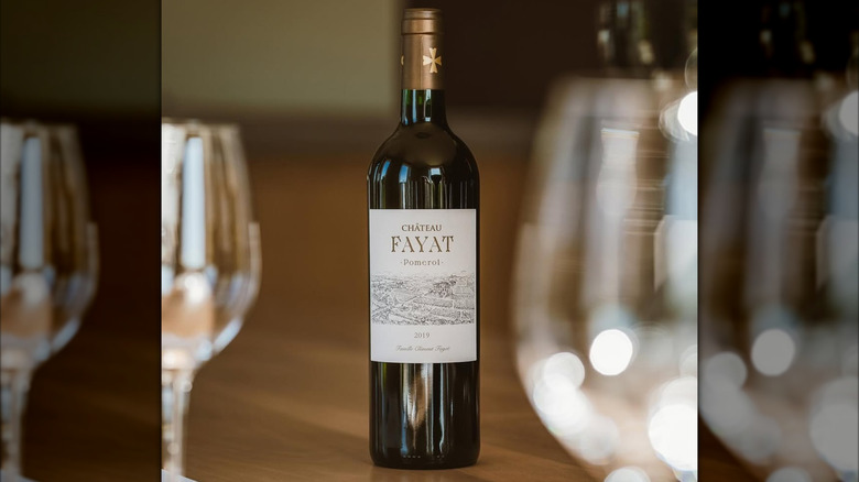 A bottle of Château Fayat Pomerol with glasses