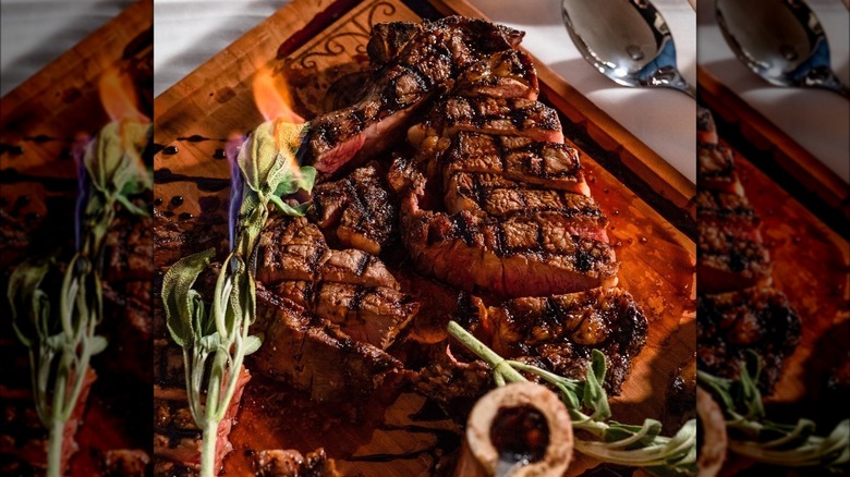 Seared steak with burning rosemary