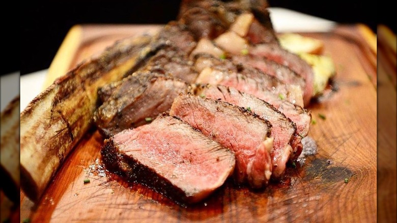 Sliced steak on wood board