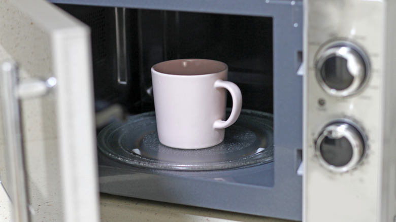 Mug inside open microwave