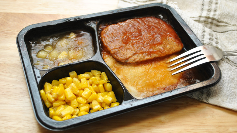 Microwave dinner with meat and corn