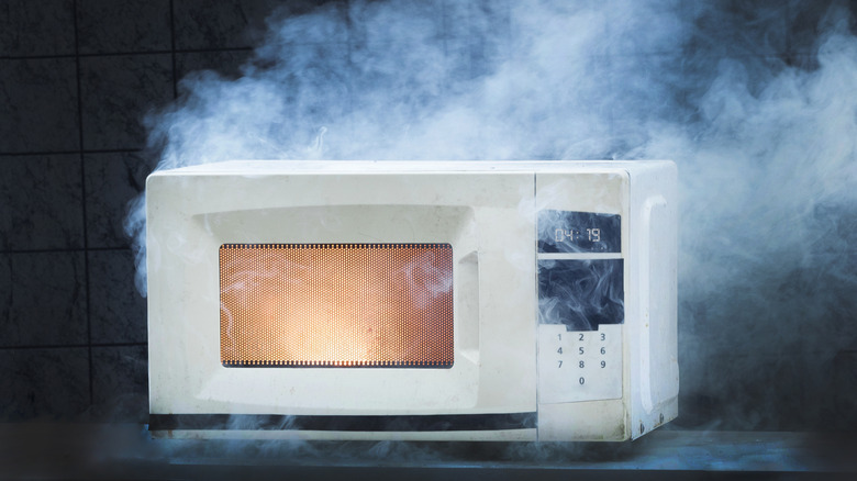 Microwave with smoke coming off of it
