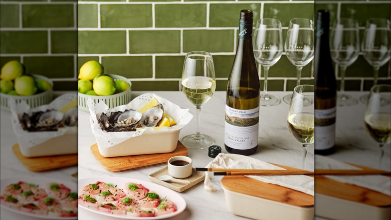 bottle of wine with glasses and seafood spread