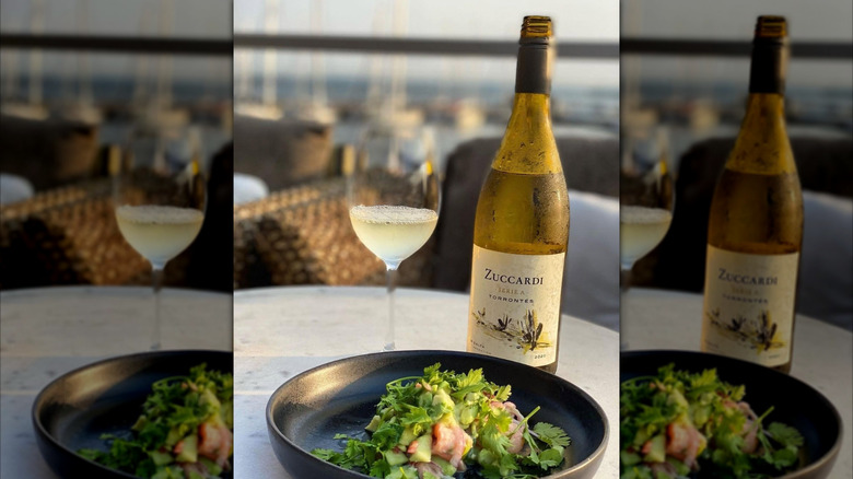 bottle and glass of white wine with salad