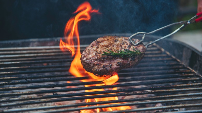 Person grilling meat