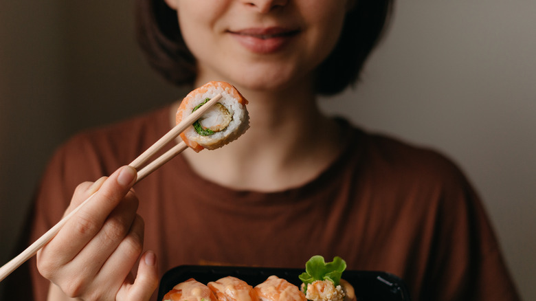 Eating sushi with chopsticks