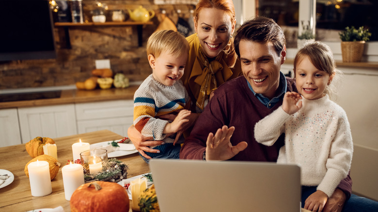 People waving to computer