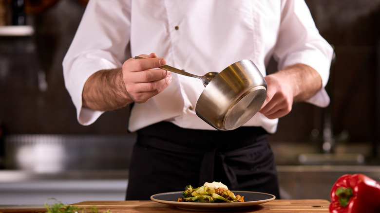 Chef preparing plate in kitchen