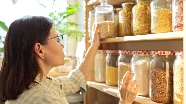 Person organizing pantry jars