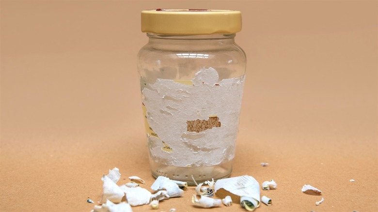 Glass jar with half-removed label