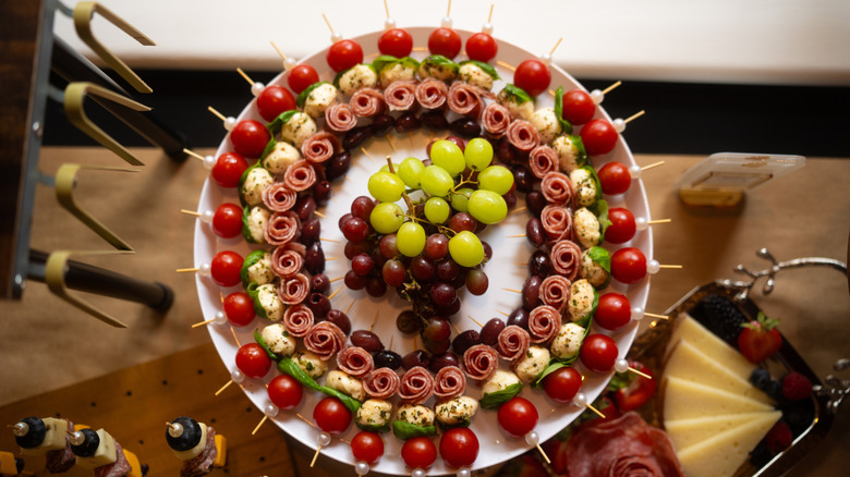 Charcuterie board wreath on plate with grapes