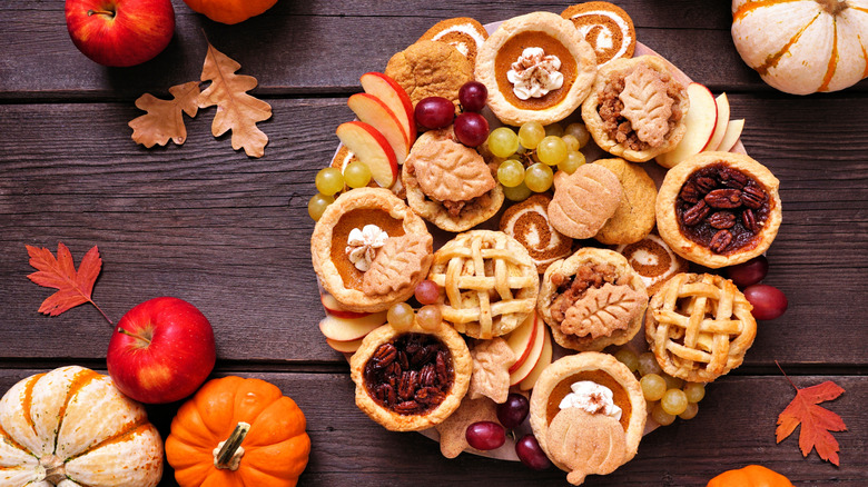 Pie charcuterie board with mini pies nd grapes