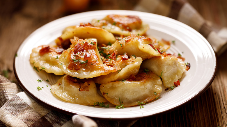 Cooked pierogis on plate bacon