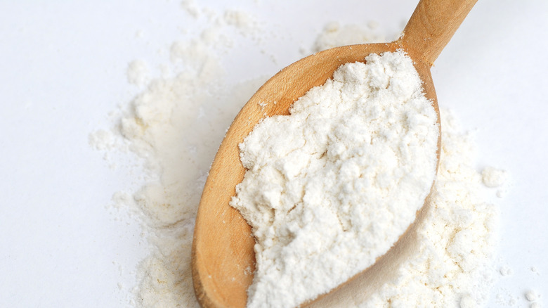 Wheat flour with wooden spoon