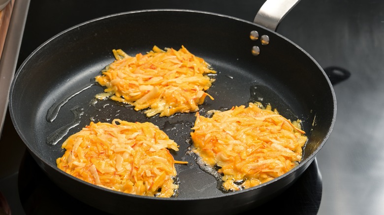 Hash browns frying in skillet