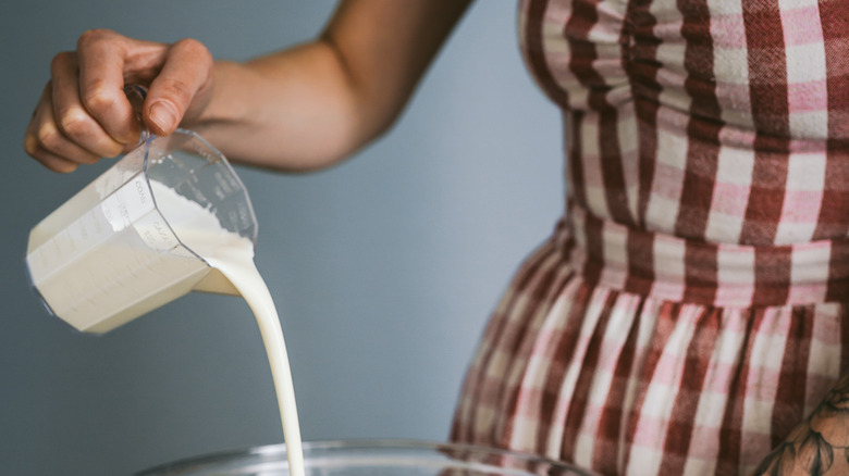 Woman pouring heavy cream