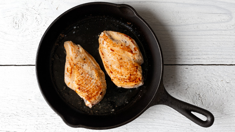 Two chicken breasts in pan