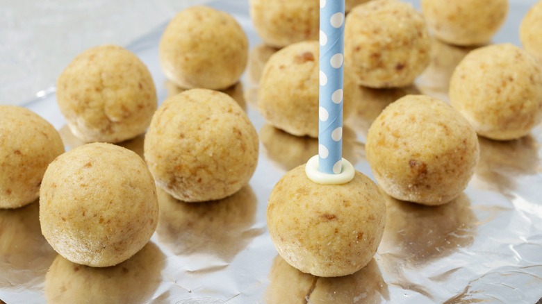 inserting sticks into cake balls