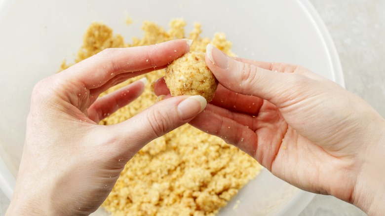 hands forming cake balls